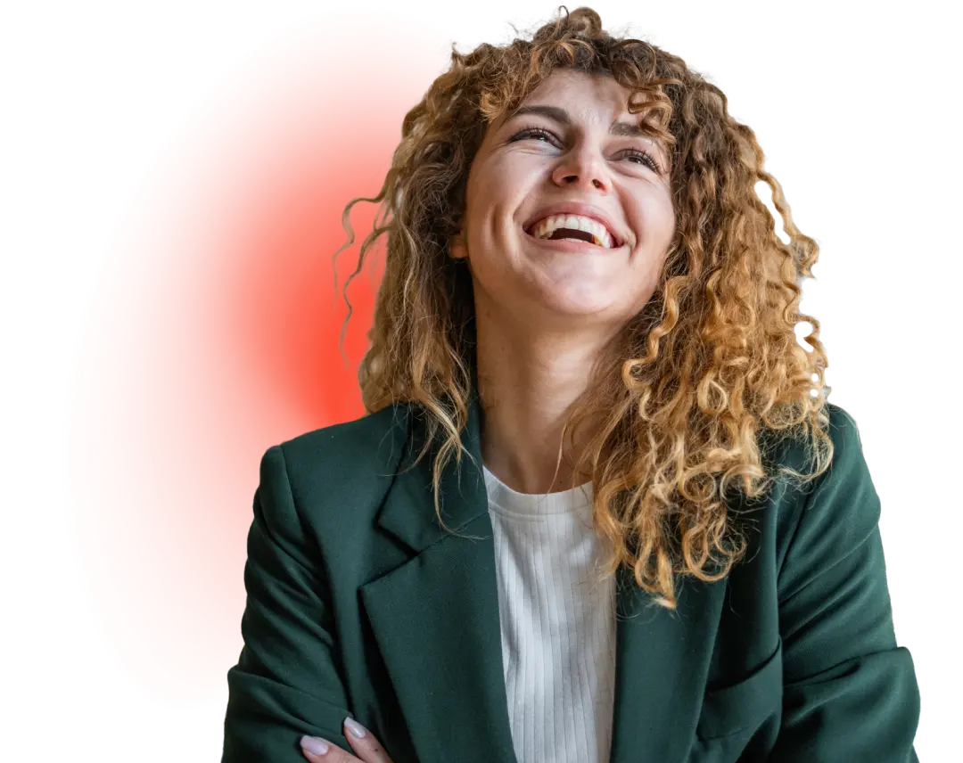A person with curly hair wears a green blazer and white shirt, posing confidently against a dark background with a red gradient.